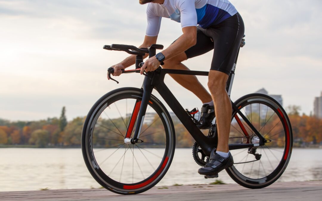 Triathlete,Rides,Along,Waterfront,Path,During,Autumn,Afternoon,In,A